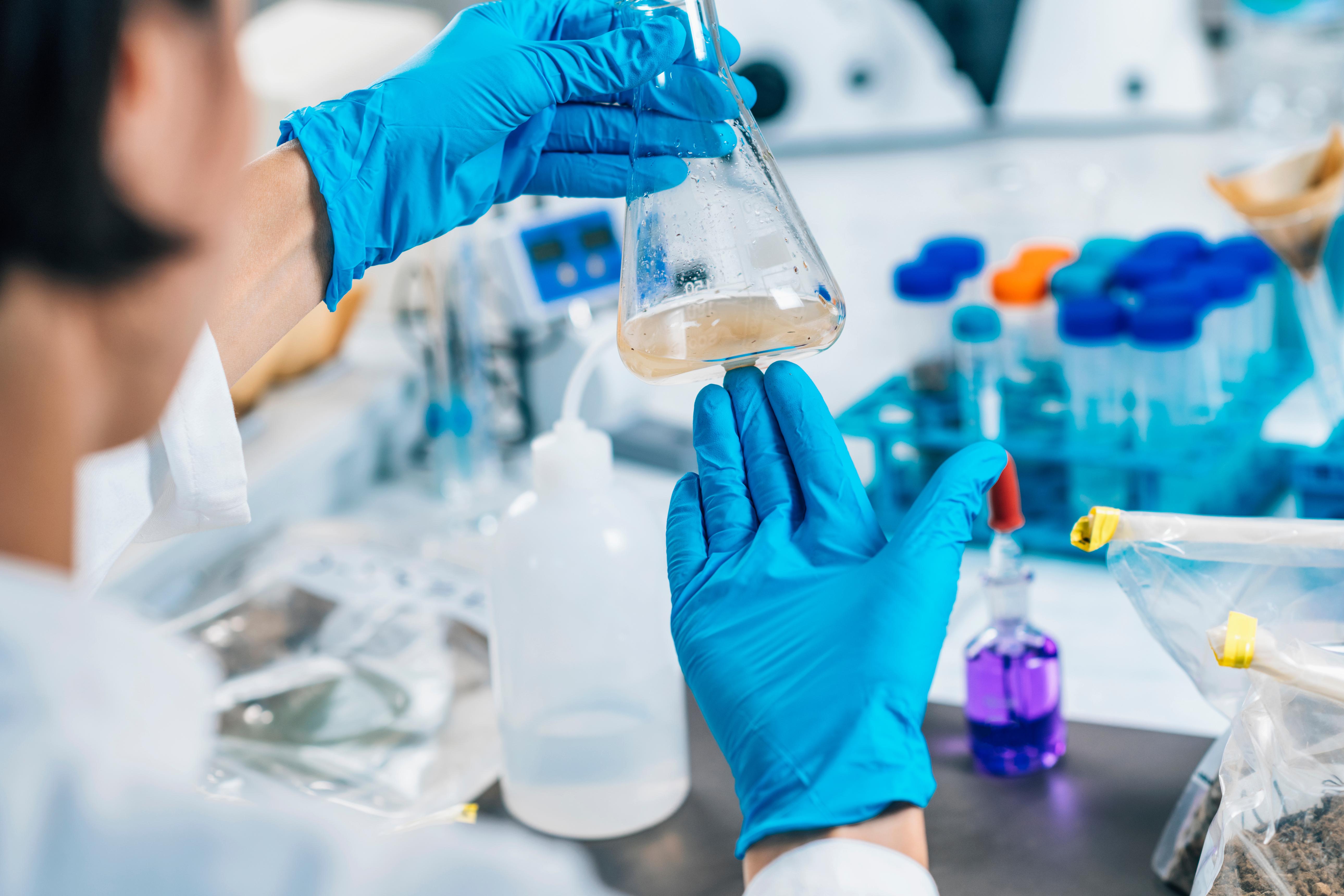 lab woman holding chemistry equipment