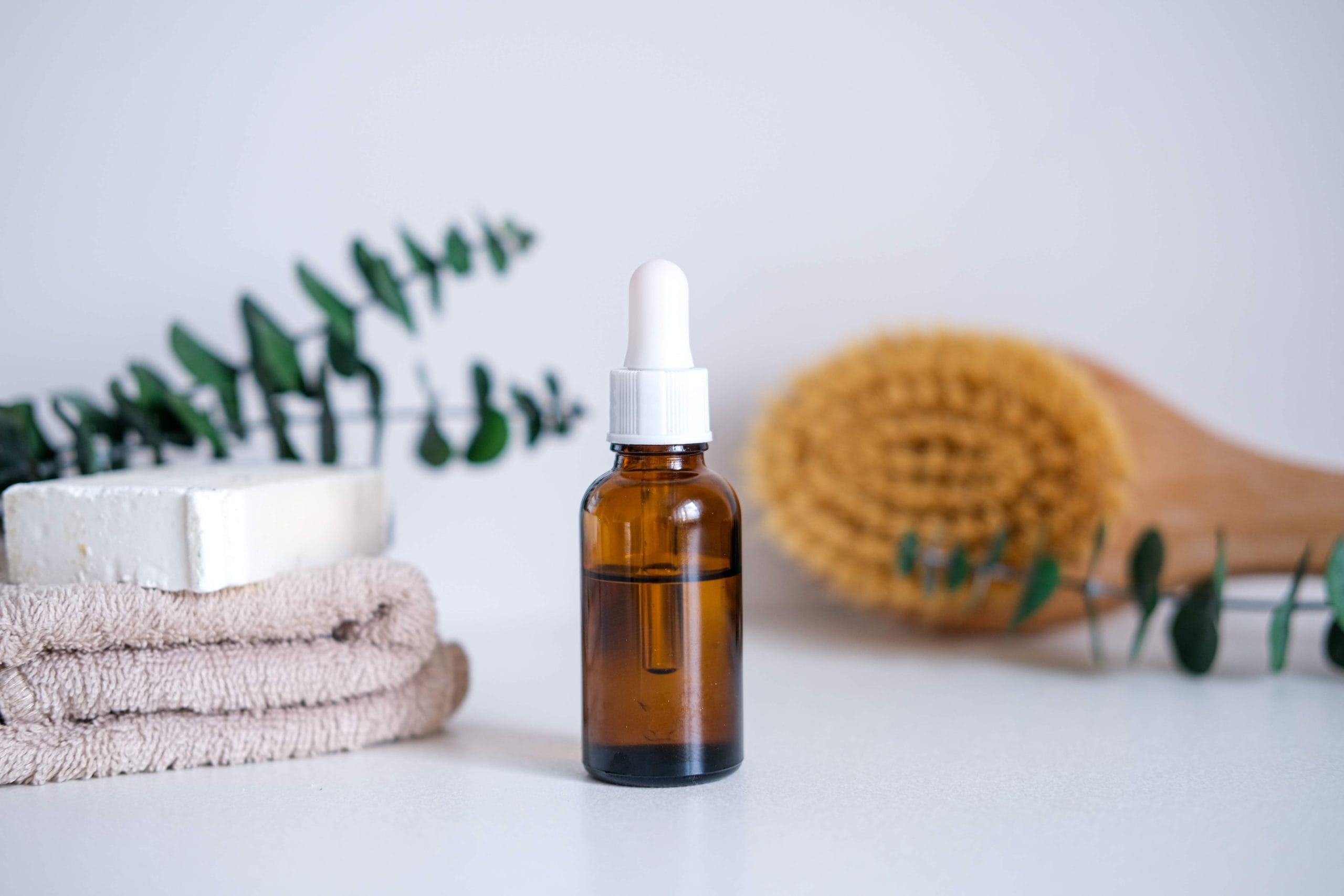 Dark glass bottle with squalane, serum, essential oil, cosmetic among spa care products. Natural organic cosmetics, eco or bio concept