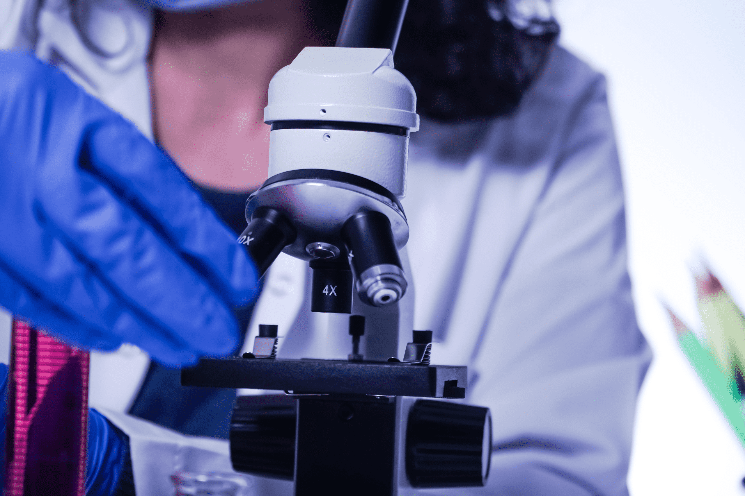 close up of a microscope and a woman looking into it uv stabilizer