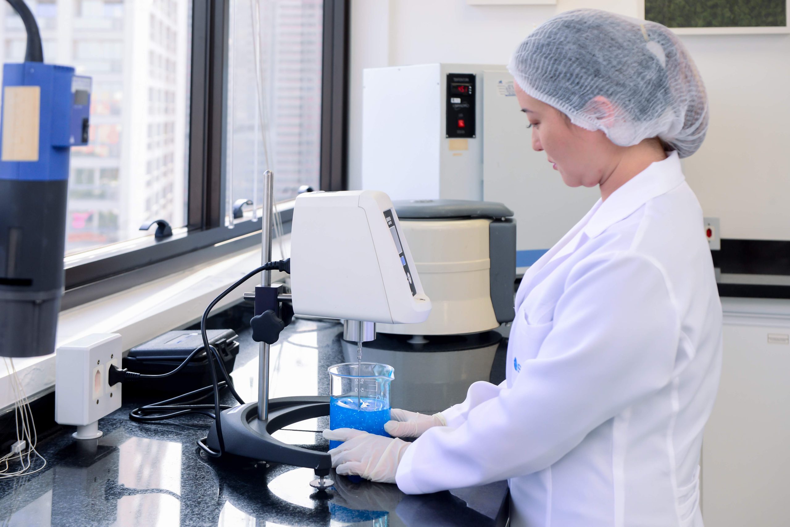 Woman looking into a microscope