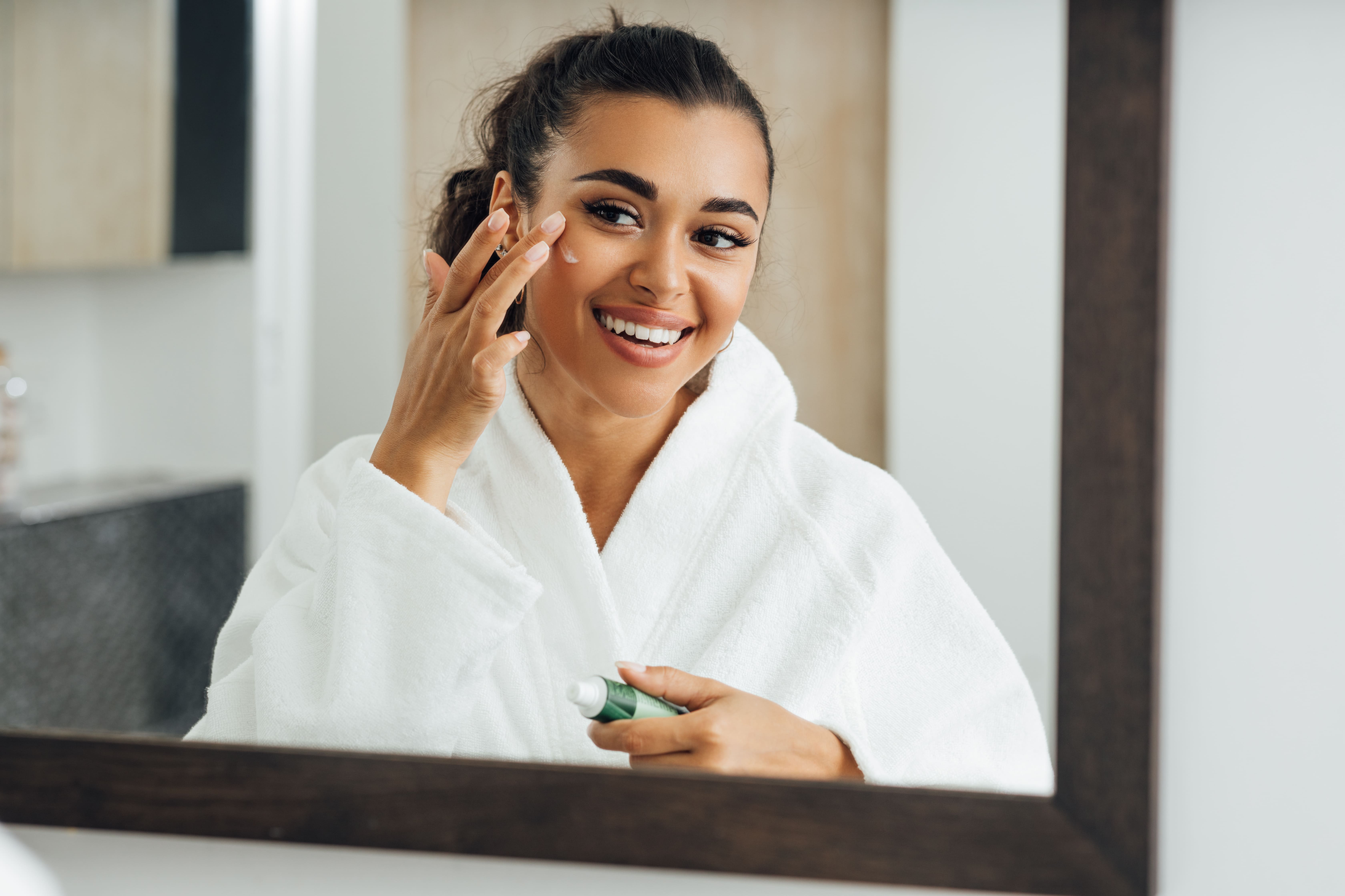 woman putting facecream on